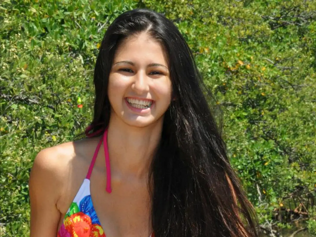 Model Maya Jama demonstrates her stunning physique in a deeply plunging swimsuit, basking in the...