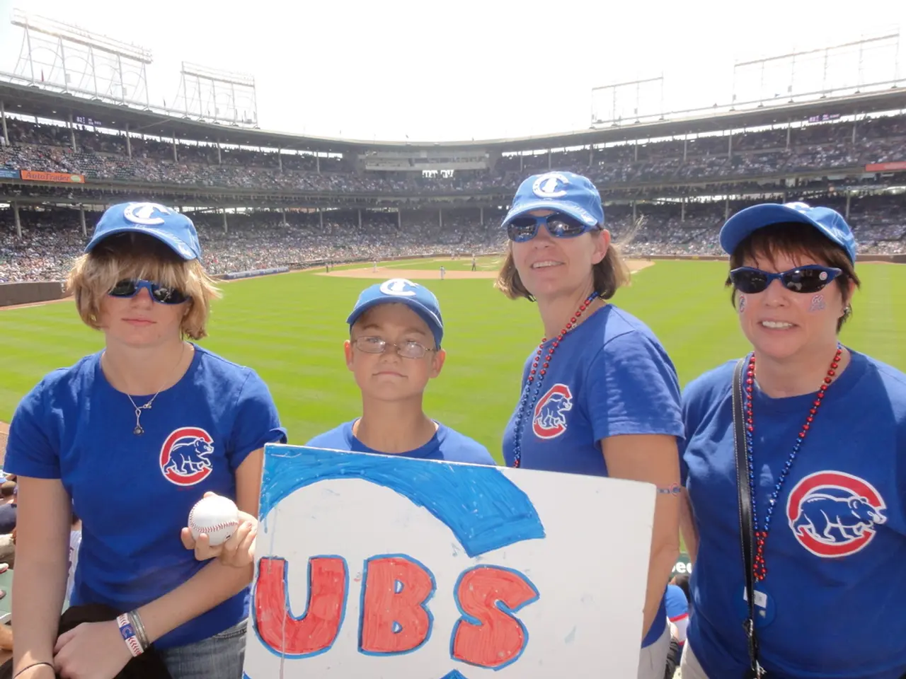 In the image there are three ladies with caps and goggles. There is a boy with spectacles and a cap...