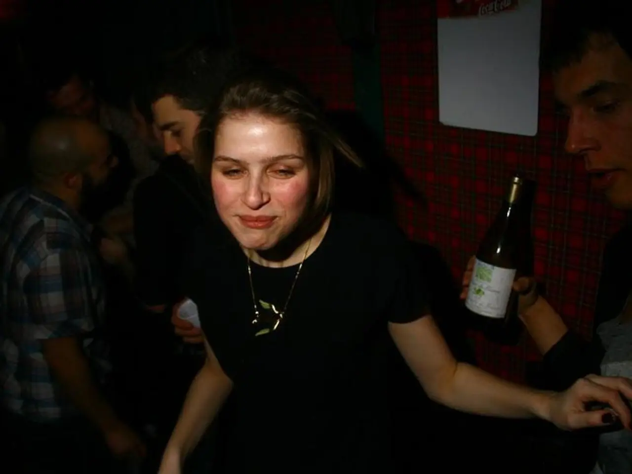 This image is clicked inside the room. There are many people in this image. In the front, the woman...