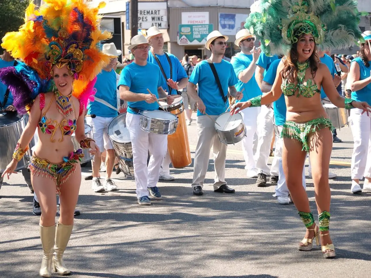 In this picture there two girls were dancing. And some of the men are wearing the blue t-shirt and...