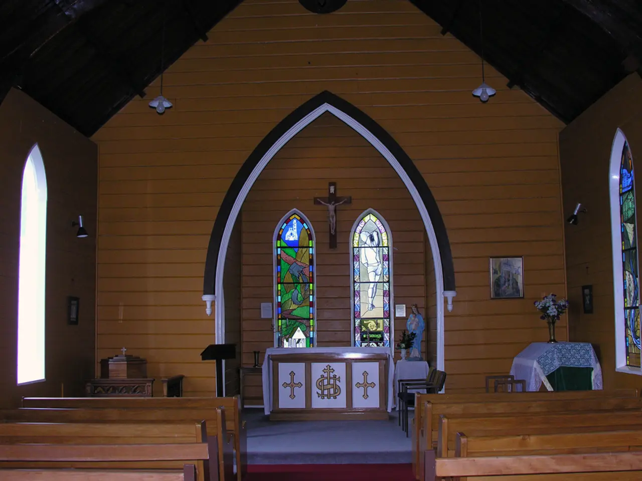 This image is taken inside the church where we can see there are benches on either side of the...