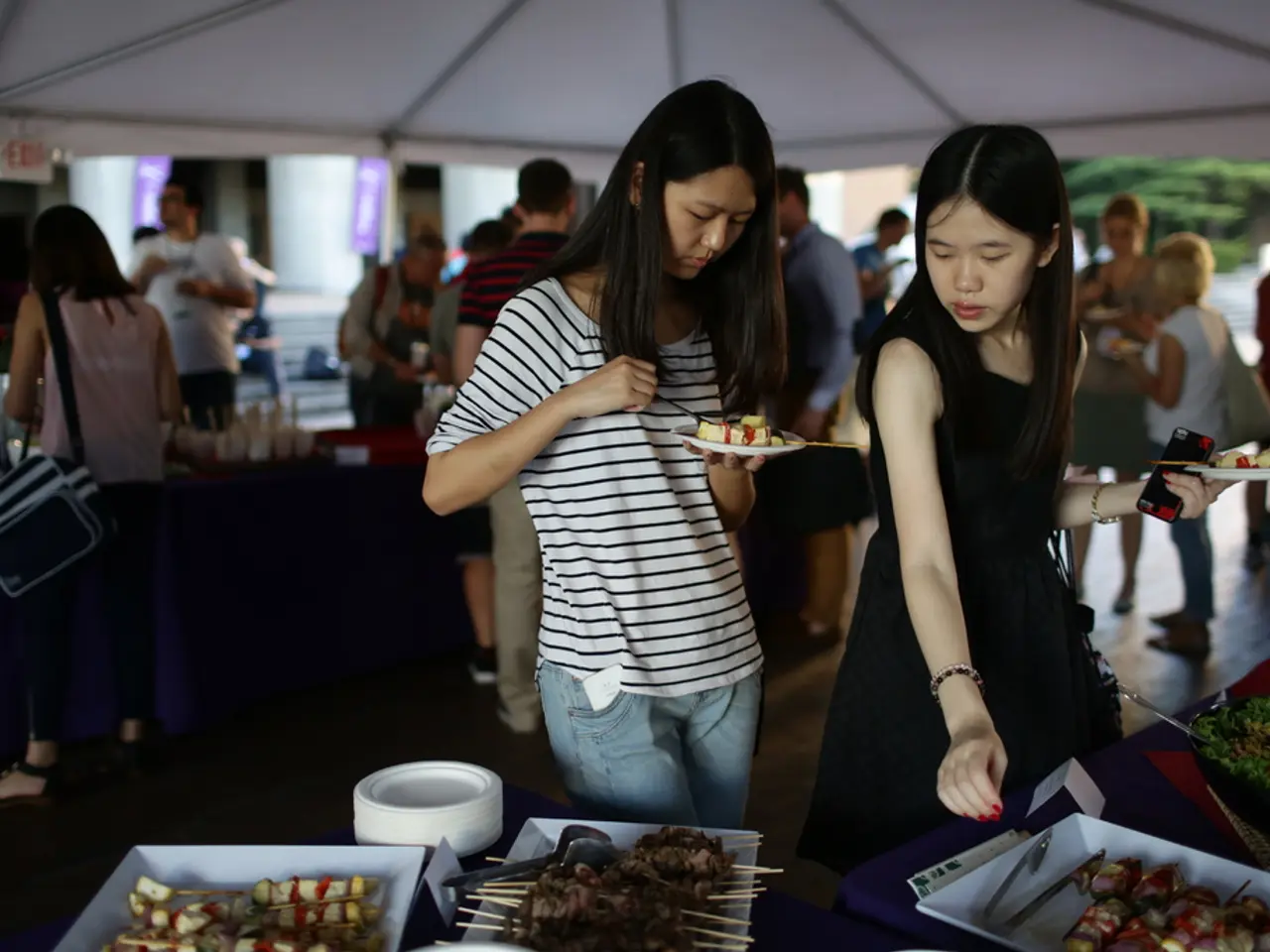 At the top of the image I can see the tent. Here I can see two women standing and holding the...