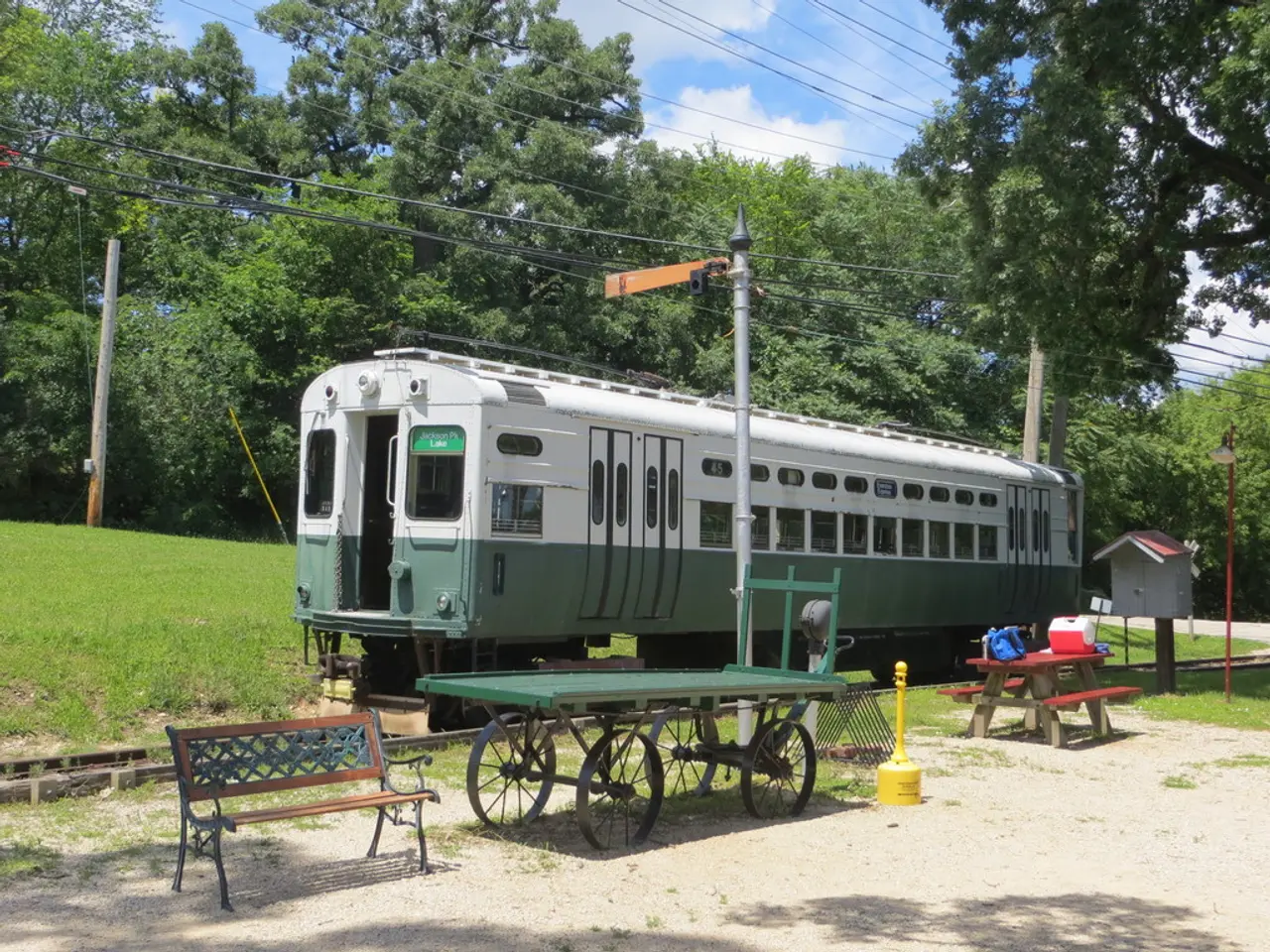 In this picture there is a train, there is a track and a bench here is another table and bench you...
