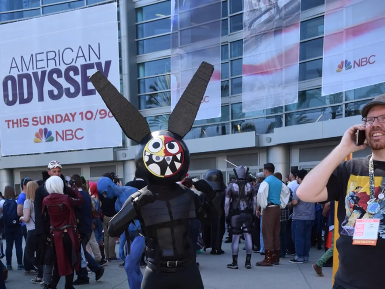 In this image there is a man with drama costume is standing in the middle behind him there are so...