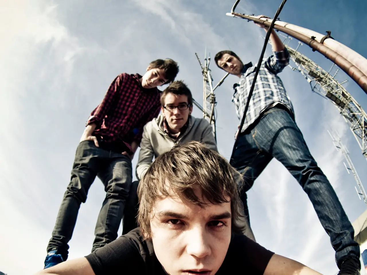 In this picture we can see a boy lying on the ground and looking at the camera. Behind there are...