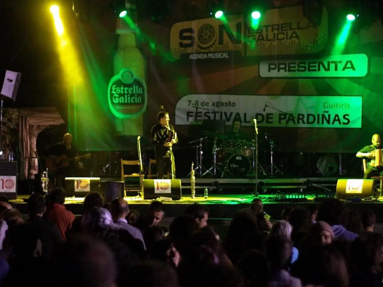 Here we can see the audience. On this stage, these people are playing musical instruments and we...