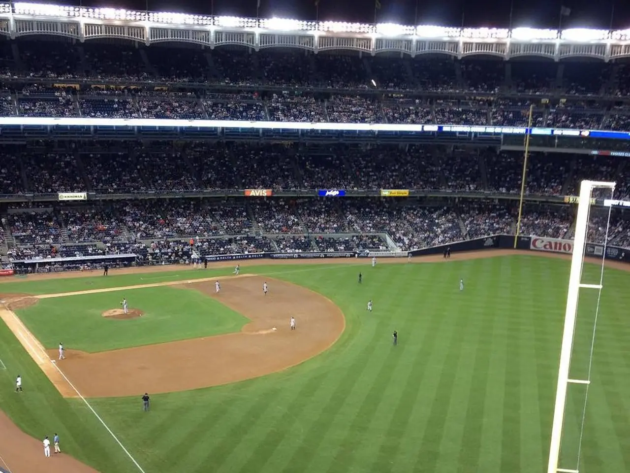 In this picture I can see it looks like a stadium, at the bottom there is the ground, few people...