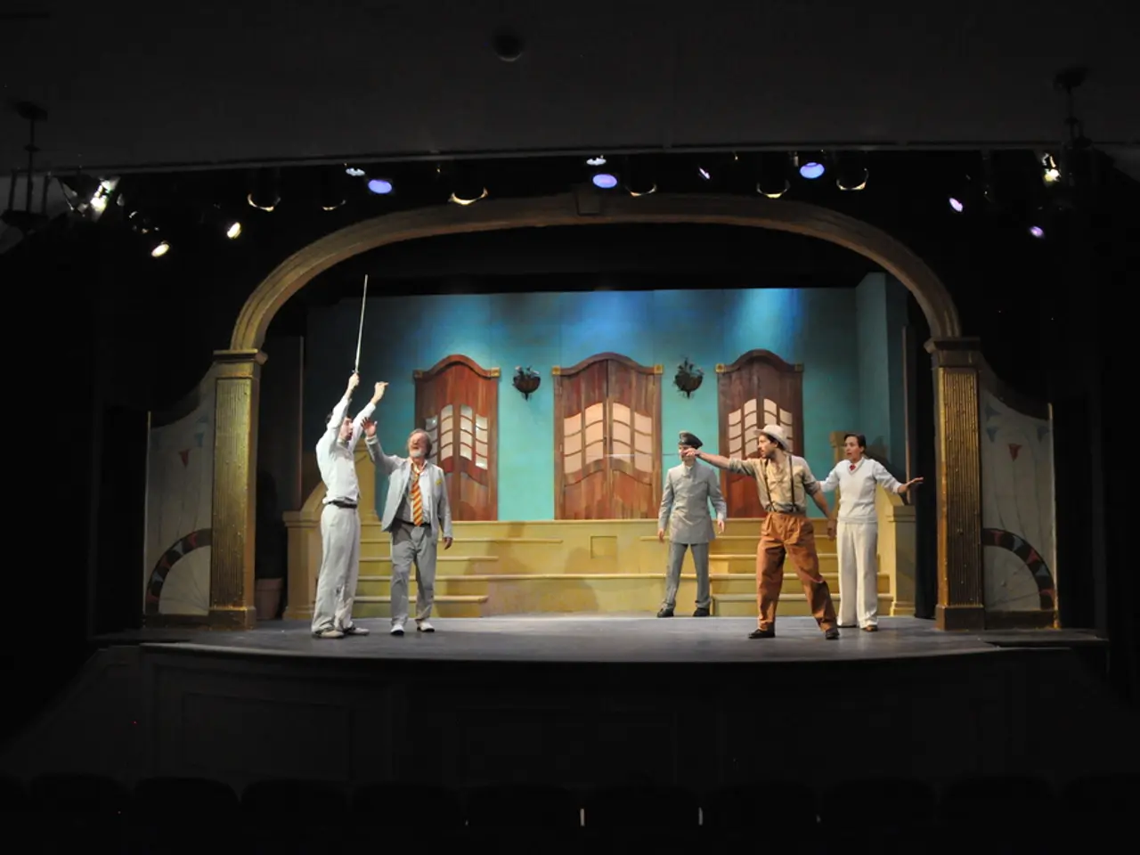 This image consists of five persons. Its looks like they are acting in a play. In the background,...