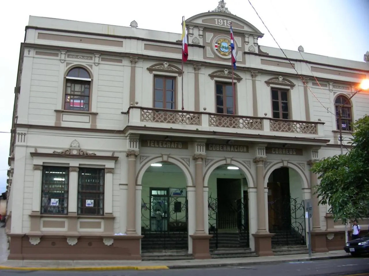 There is a building with windows, balcony, railing, steps, gates, doors. On the building there are...