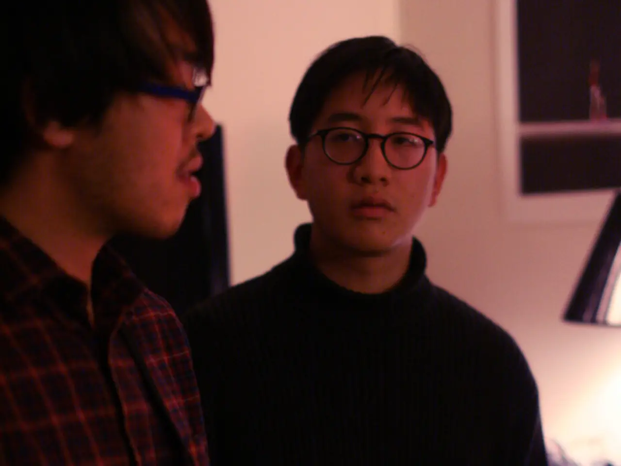 This Picture describe about the two guys standing beside each other, Left boy wearing red check...