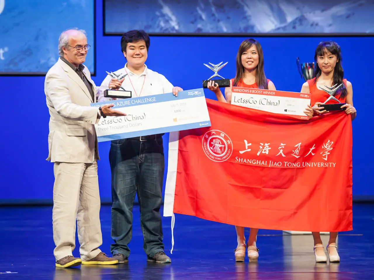 Here in this picture we can see four people standing on a stage and they are carrying awards in...