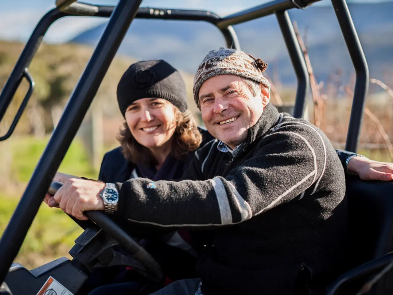 In this image there is a jeep in that jeep there is man and woman are sitting, in the background it...