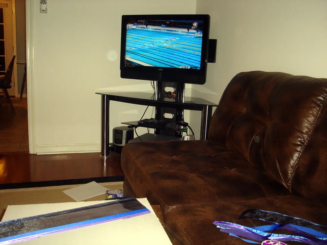 There is a room in the given picture in which a sofa, TV are located. The television is placed on...