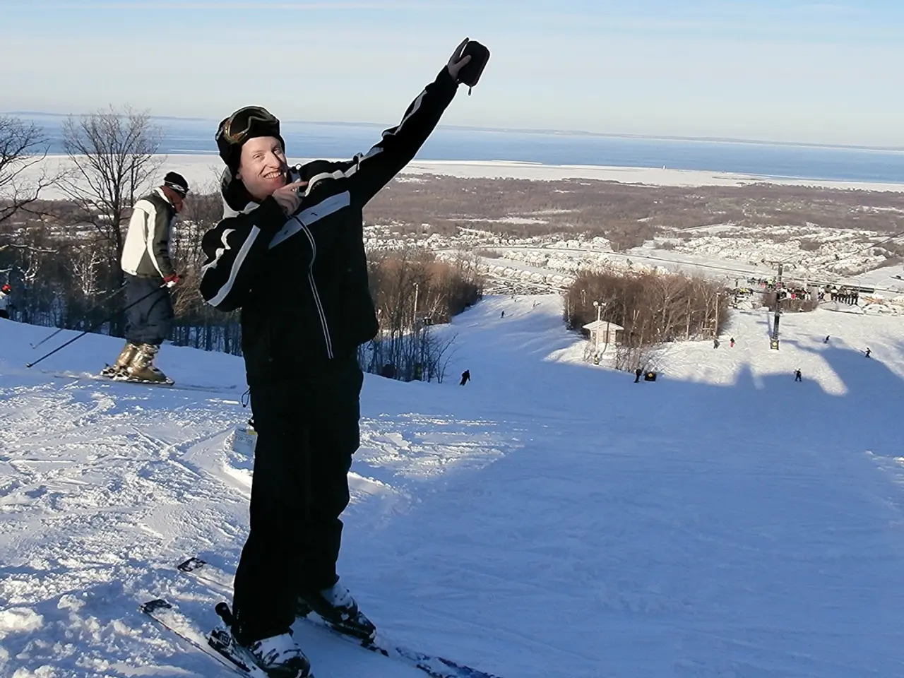 In the center of the image there is a person with ski board on the snow. In the background we can...