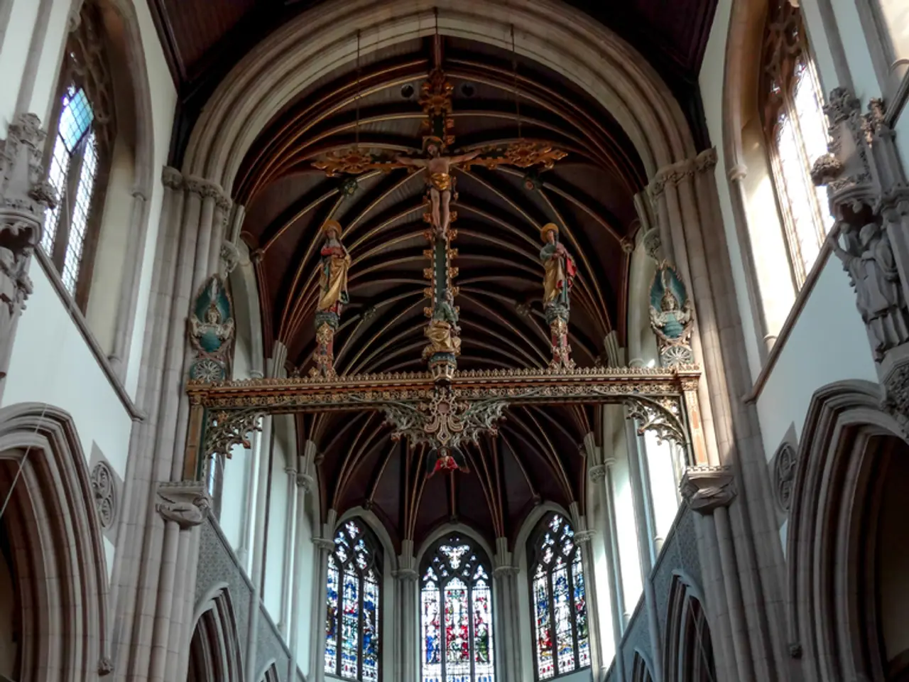 In this image we can see an inside view of the building. And we can see the wall with a design and...