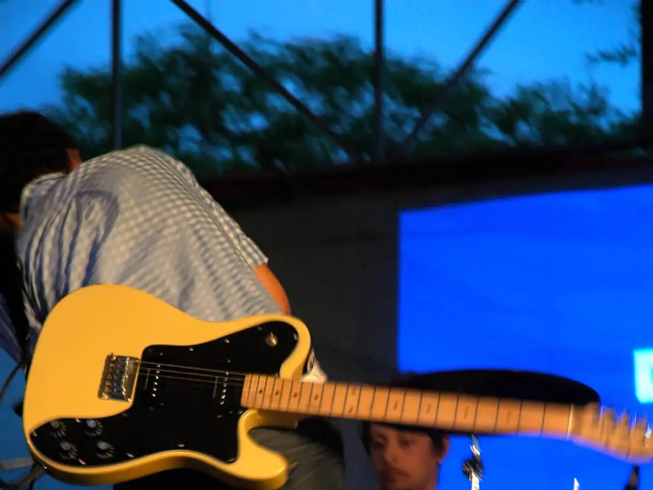 Two men are playing music on a stage.