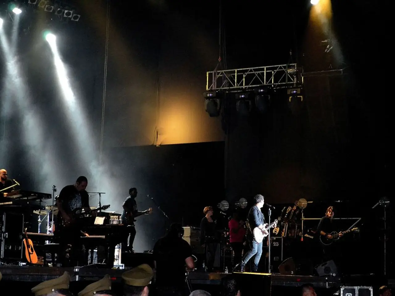 This picture seems to be clicked inside the hall. In the foreground we can see the group of people...