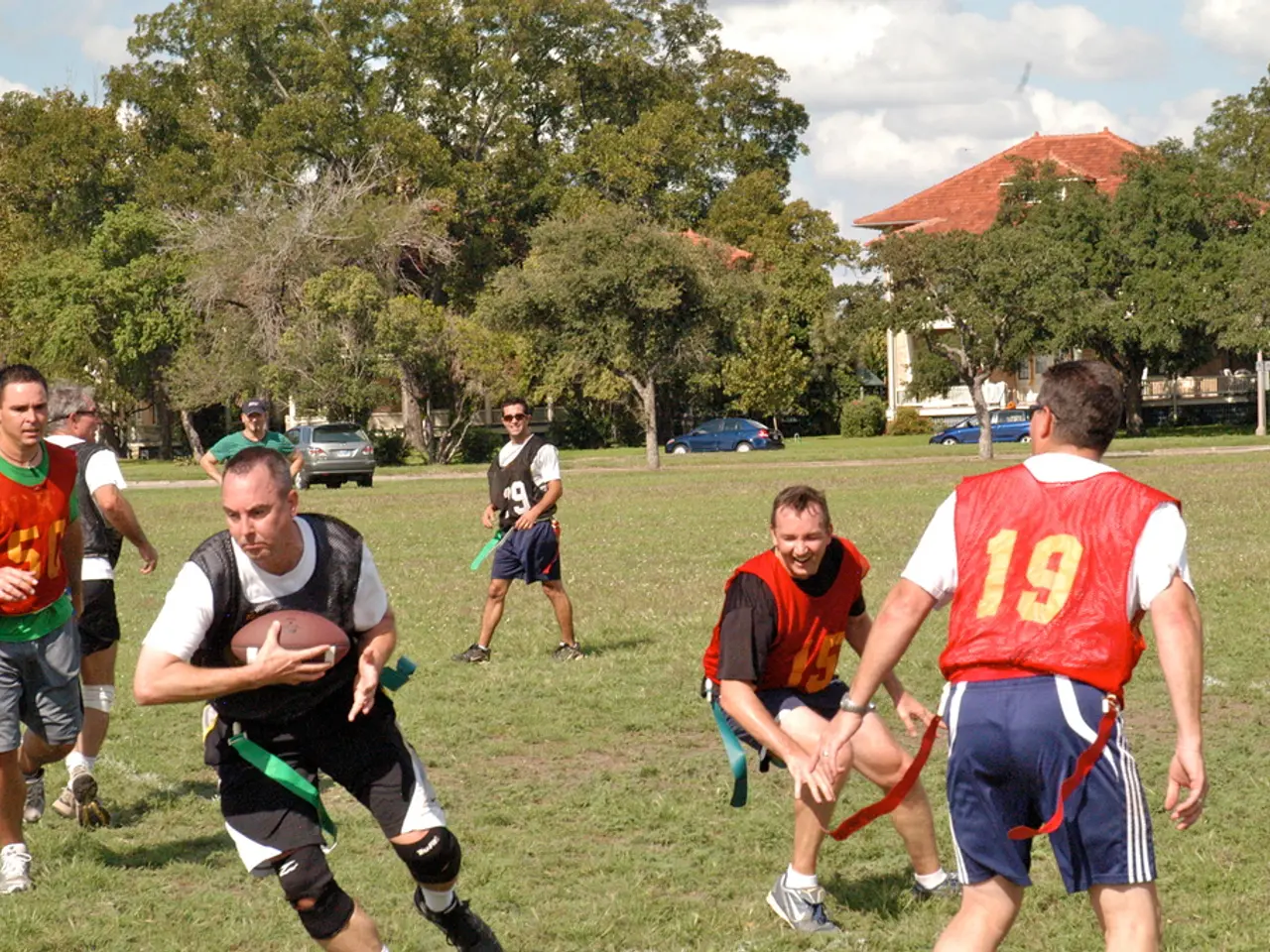 In this image there are people playing american football. In the background of the image there are...