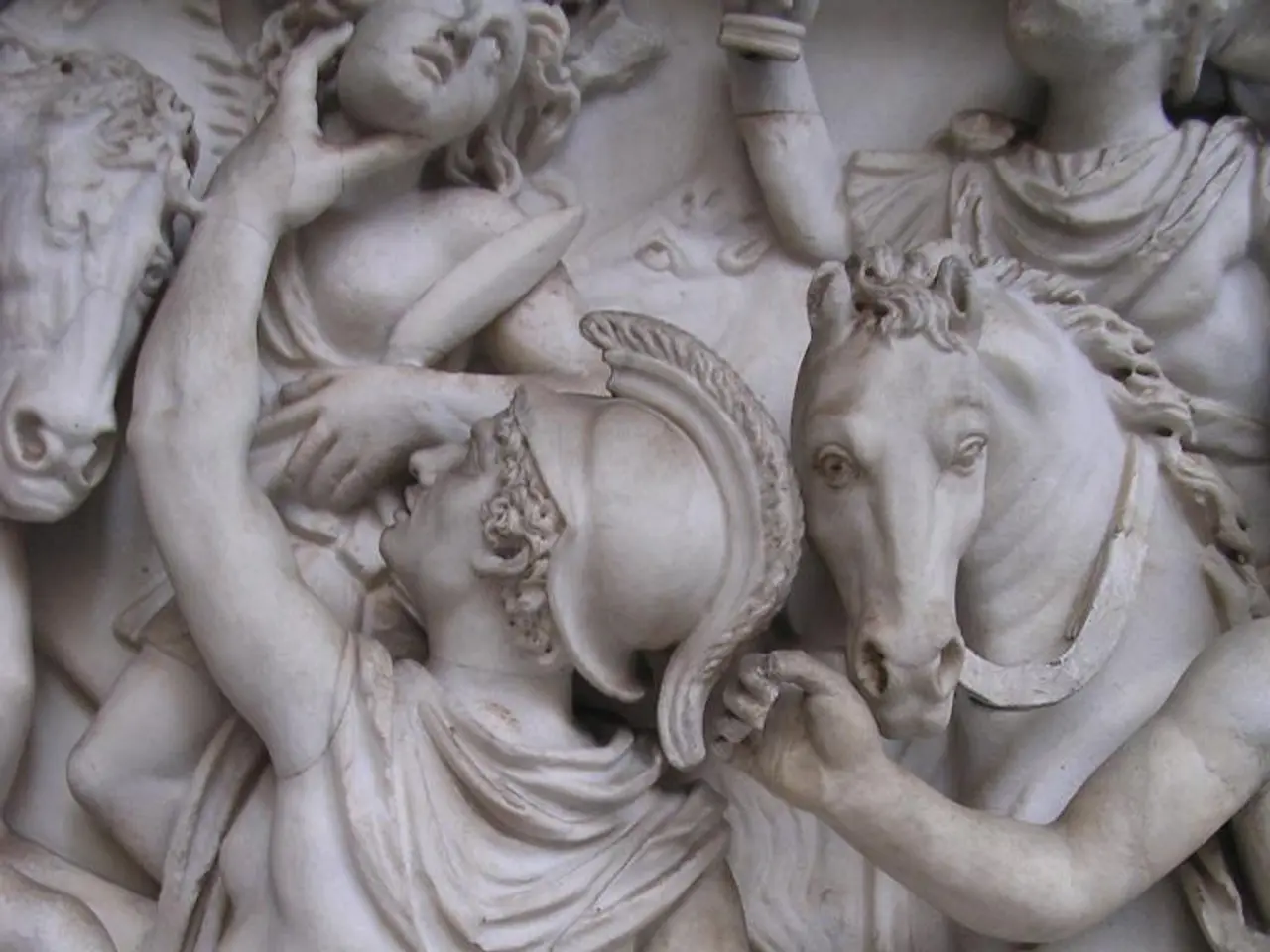 In this picture there are sculptures of group of people and there are sculptures of horses.