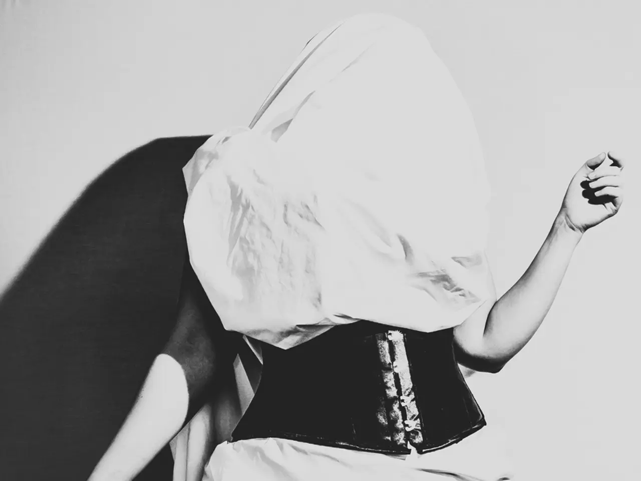 This is a black and white picture. The woman in the middle of the picture wearing a black dress is...