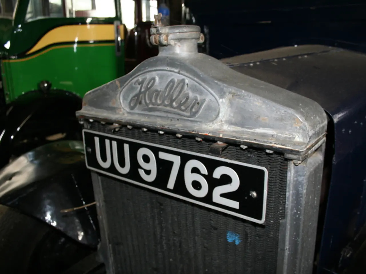 In this image we can see triumph herald and some text on it. In the background the image is in a...