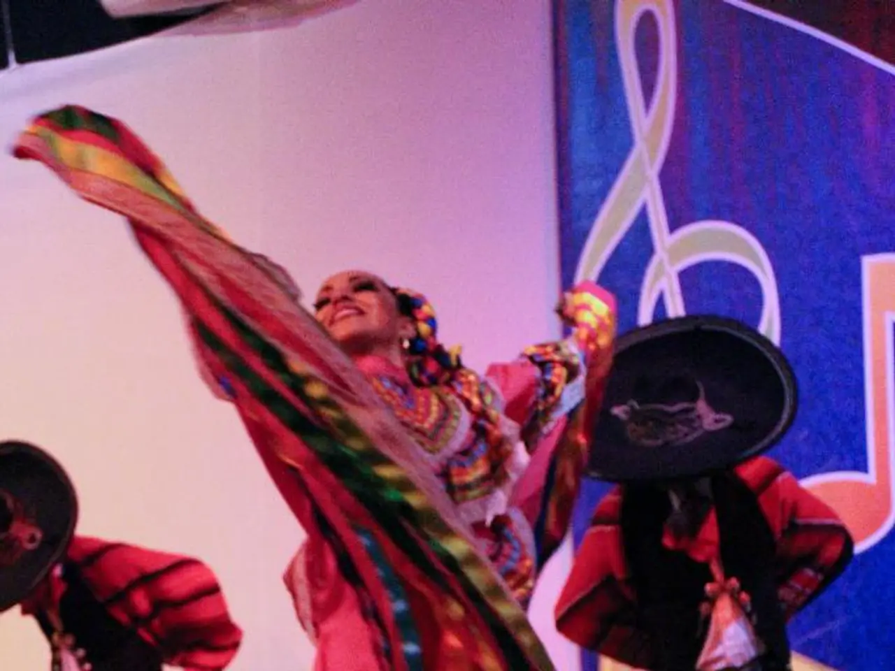 In this image we can see some people standing on the stage wearing the costume. On the backside we...