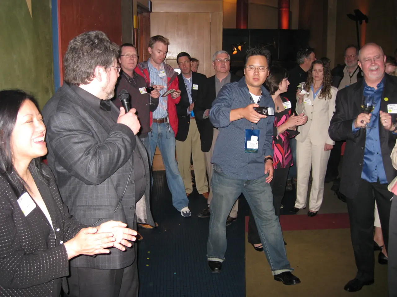 In this picture we can observe some people standing on the floor. There are men and women in this...