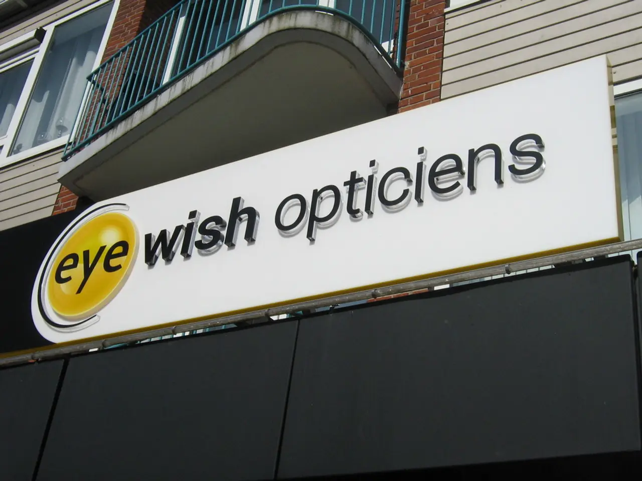 This is the picture of a building. In this image there is a hoarding on the building and there is a...