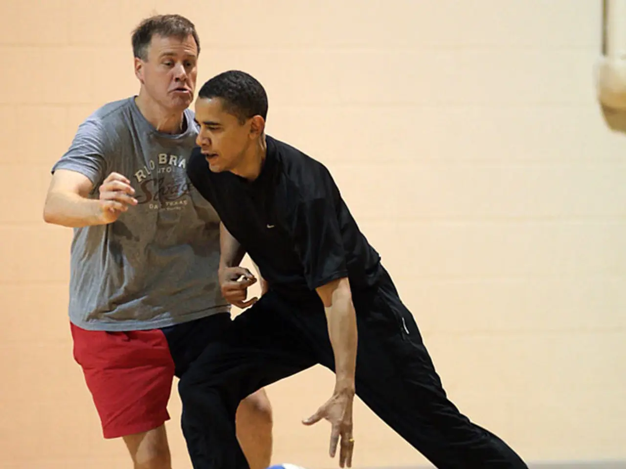 In this image there is a man running and trying to catch the ball , another man running beside him...