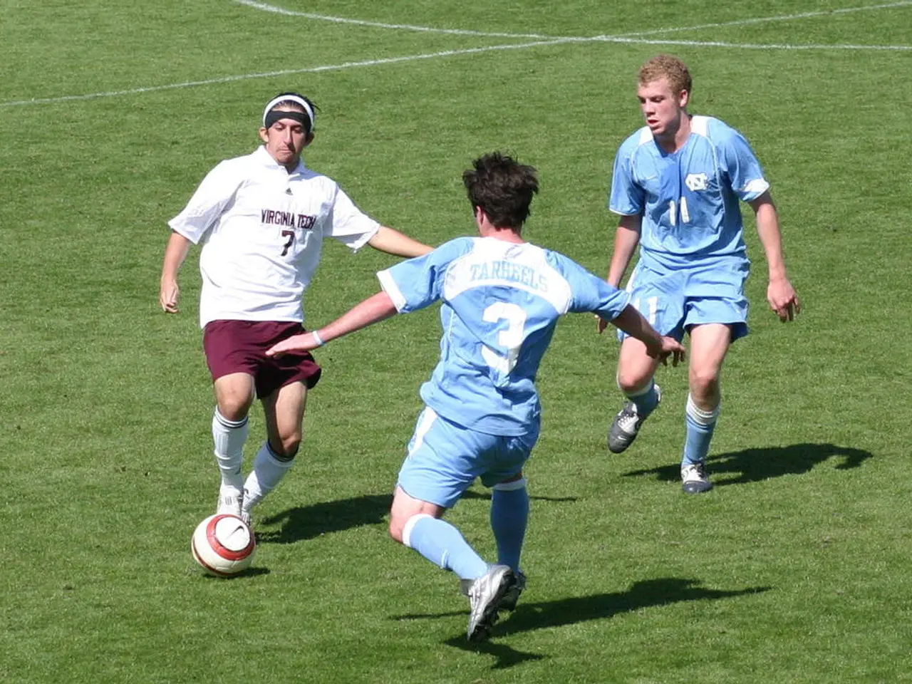 In this picture there are three men who are playing football in the ground.