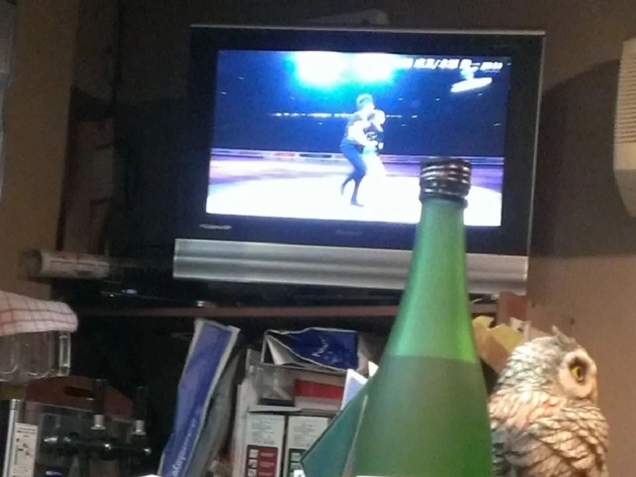 This picture is consists of a bottle which is green in color and there is a glass beside it and...