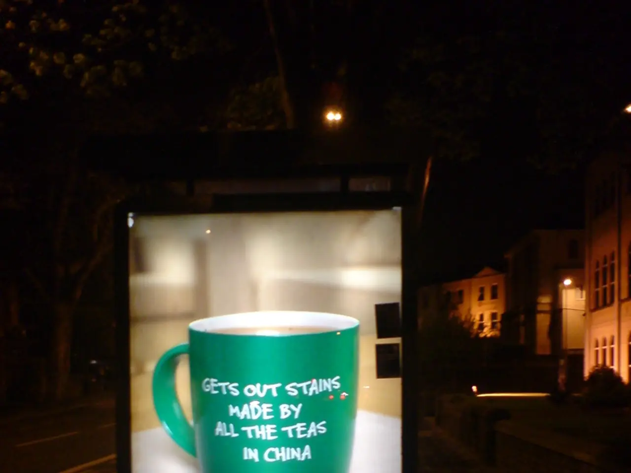 Here in this picture we can see a hoarding present and in that we can see picture of a mug present...