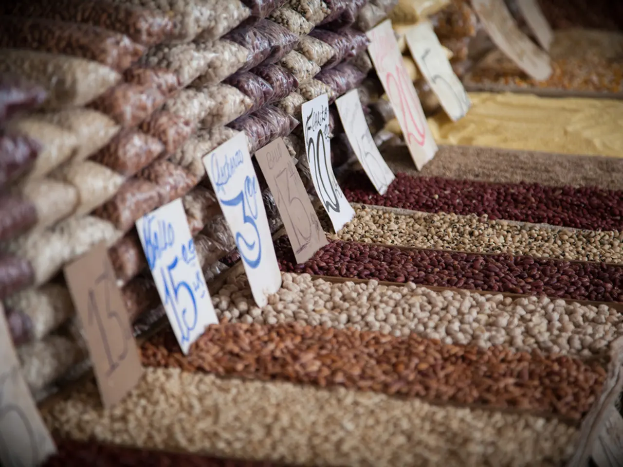 In this image, we can see grains and name boards. Here can see grains are packing with cover.