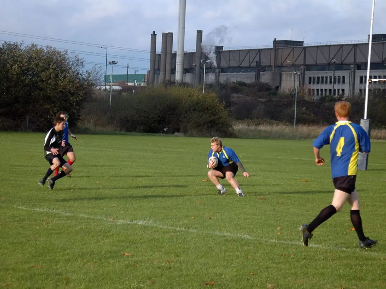 Here, some boys are playing american football. In which two are running to catch the ball. The boy...