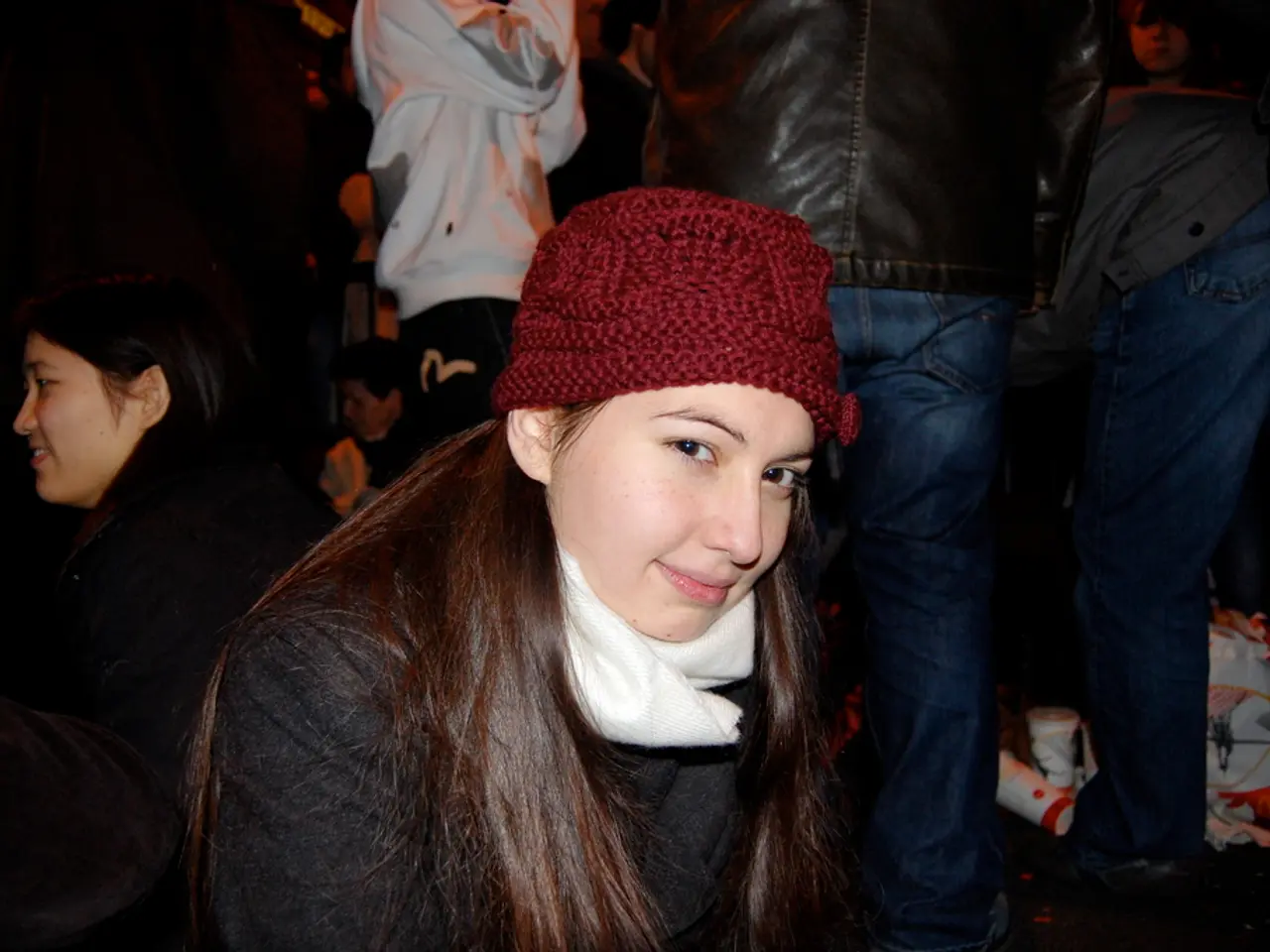 In the center of the image there is a lady wearing a red color cap and black color dress. In the...