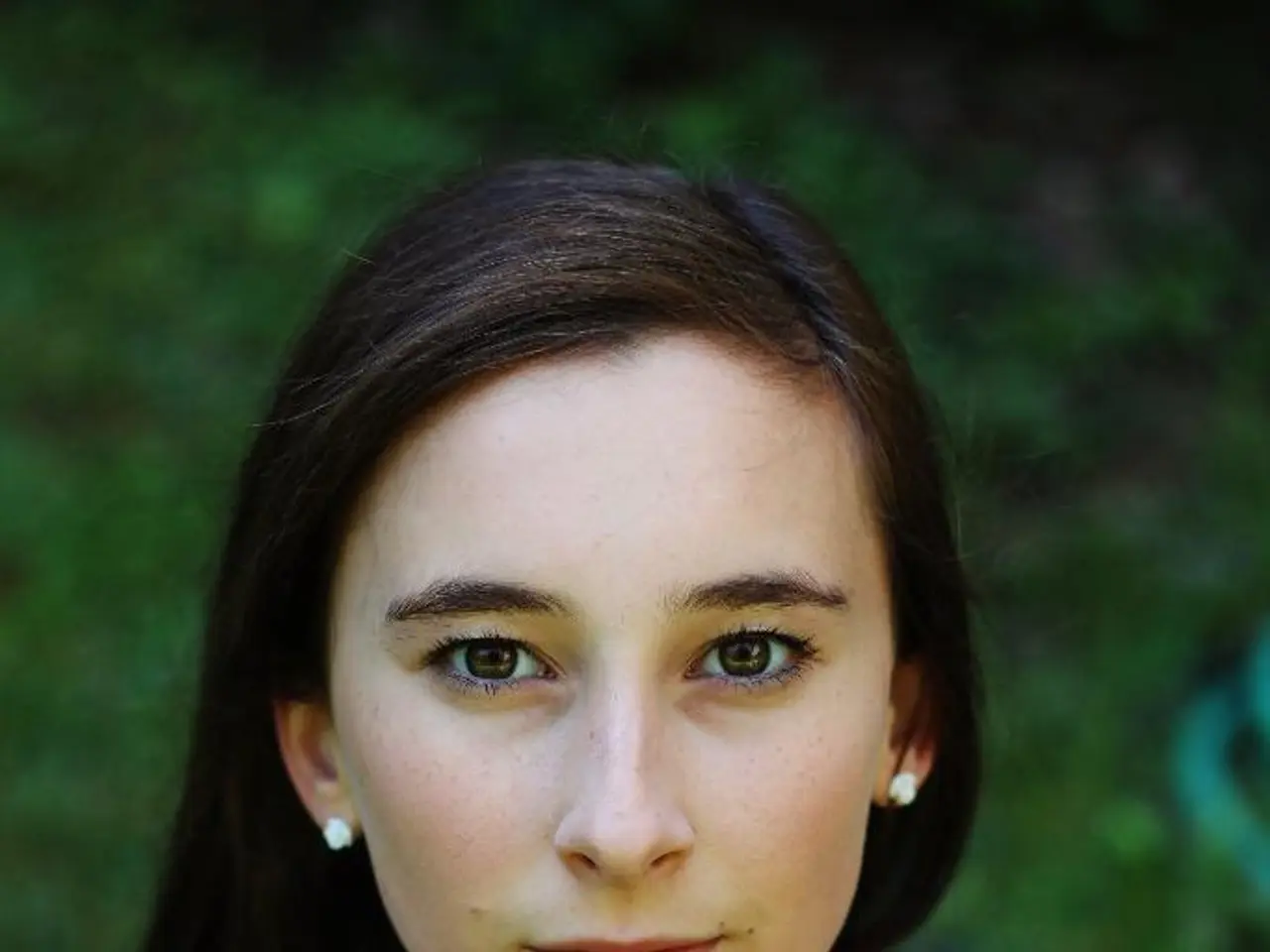 In this image I can see a woman wearing blue color dress. Background is in green and black color.