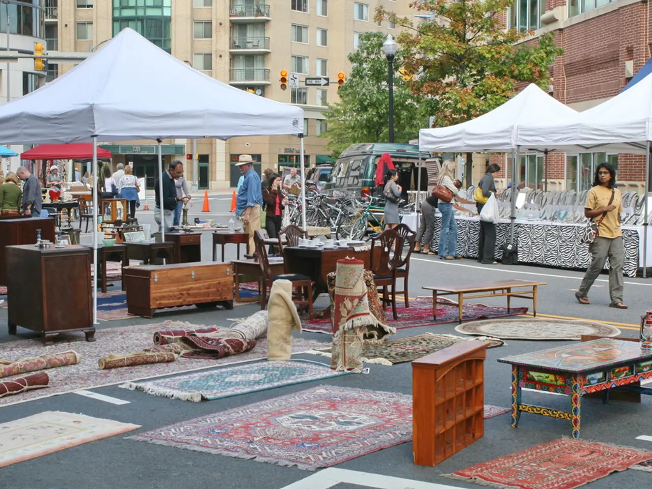 In this picture we can see carpets here and there on the road and there are tables present here and...