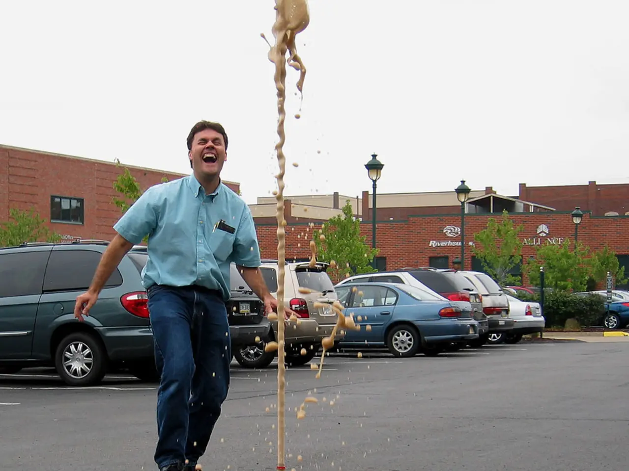 This picture is clicked outside the city on road. We see three core bottle and in the middle of...