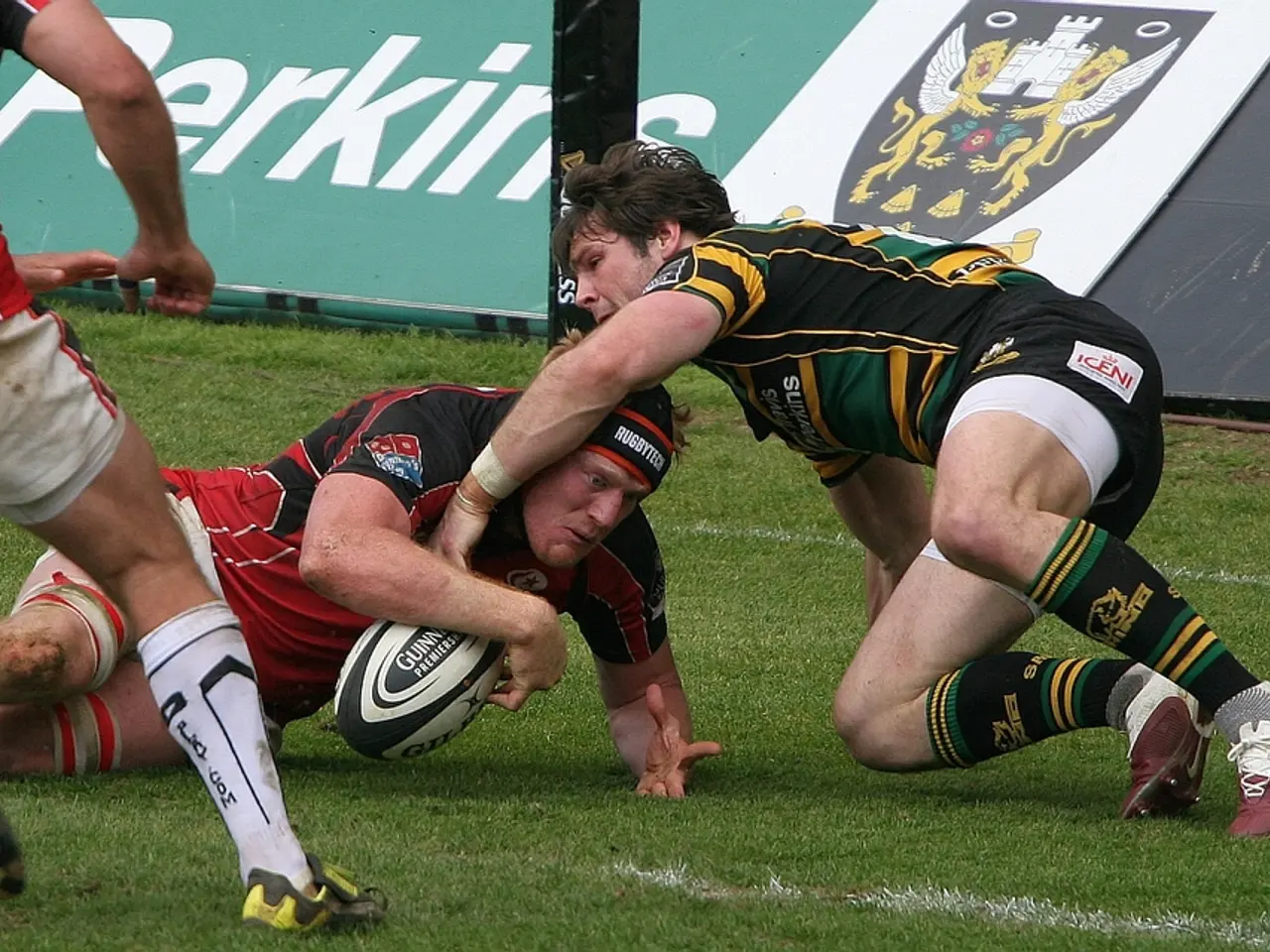 In the image we can see there are people who are on the ground and they are playing with a rugby...