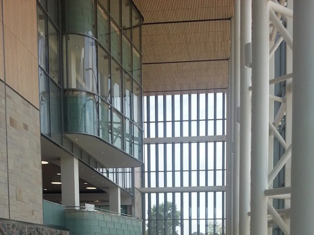 This is an inside view. On the right side there are few poles. On the left side there is a wall...