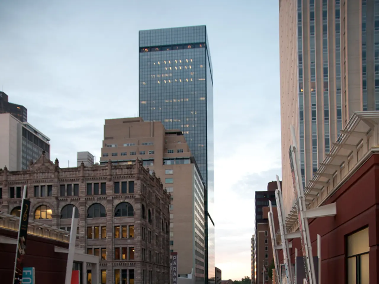 This image is clicked in the city. At the bottom, there is a road, on which there are cars. To the...