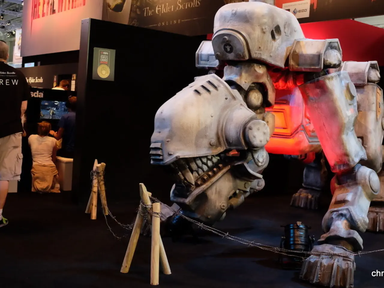 In this image in the center there is a machine. On the left side there are persons sitting, walking...