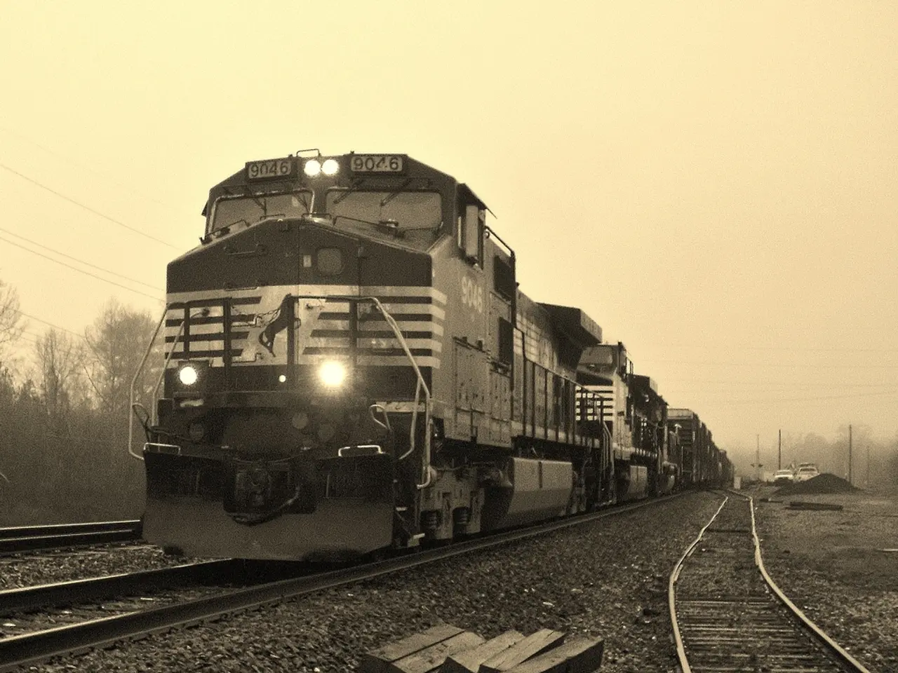 As we can see in the image there is train, railway track, cars, current poles, trees and sky.