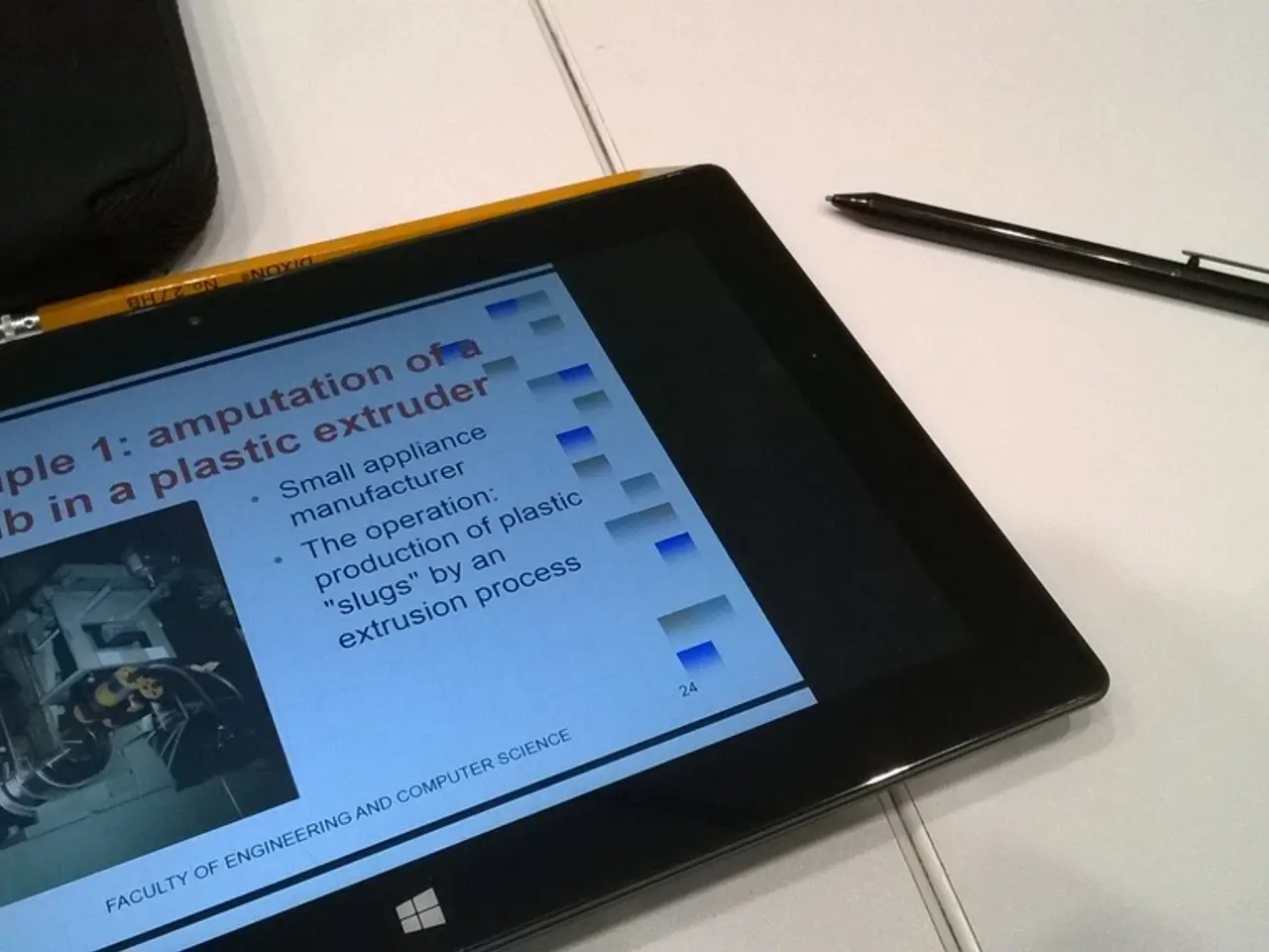 We can see tab, pencil, pen and bag on table.