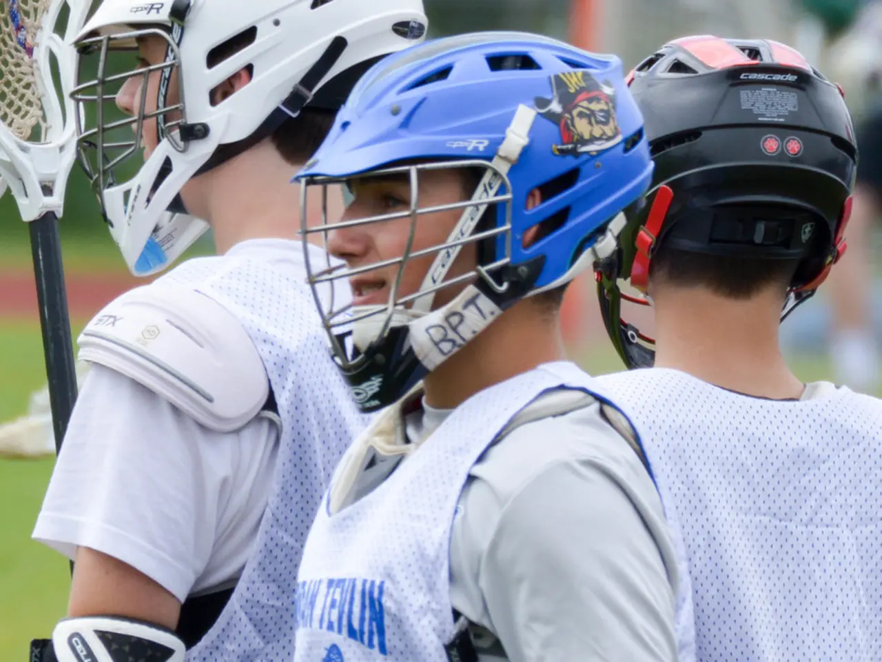 There are three players in white color jackets and wearing helmets. And the background is blurred.