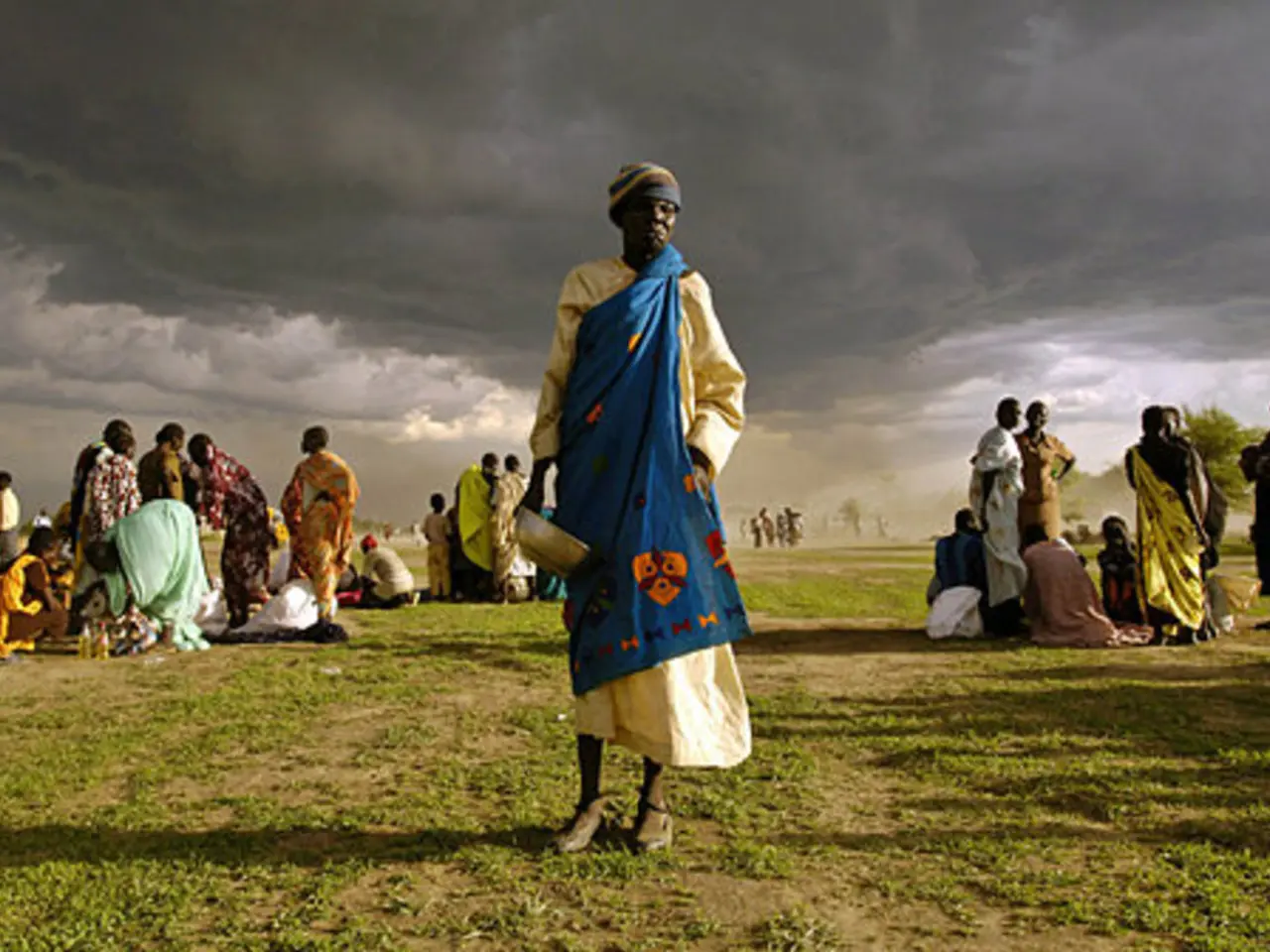 This picture describe about the women wearing blue color dress standing in the middle of the image...