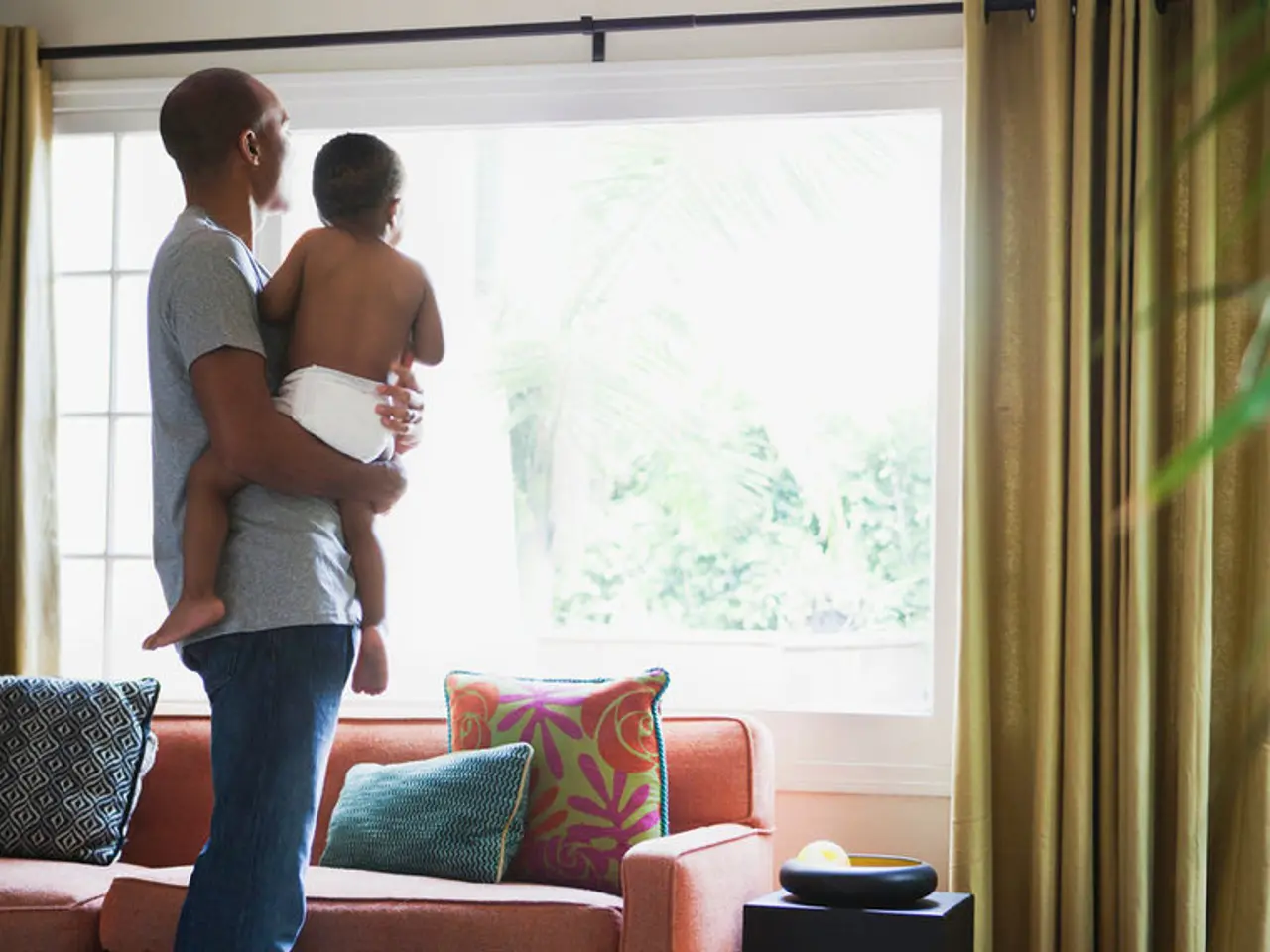 As we can see in the image, there is a man carrying a child. In front of him there is a window,...