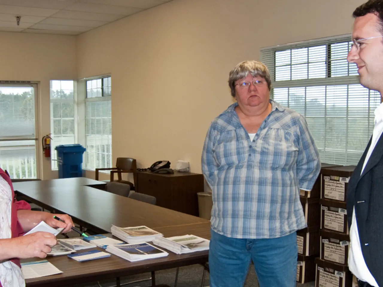 In this picture to the left there is a woman who is wearing a red jacket is standing and she is...