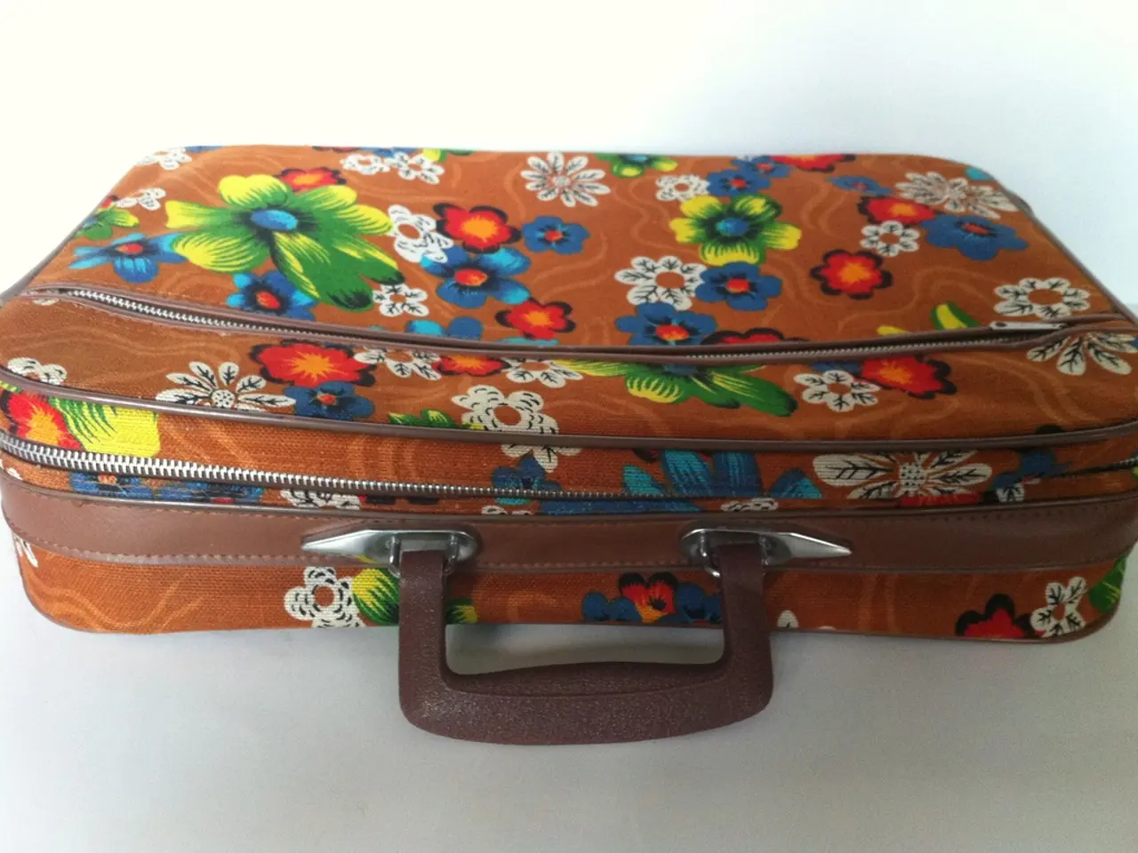 This picture shows a suitcase. with a colorful pictures on it