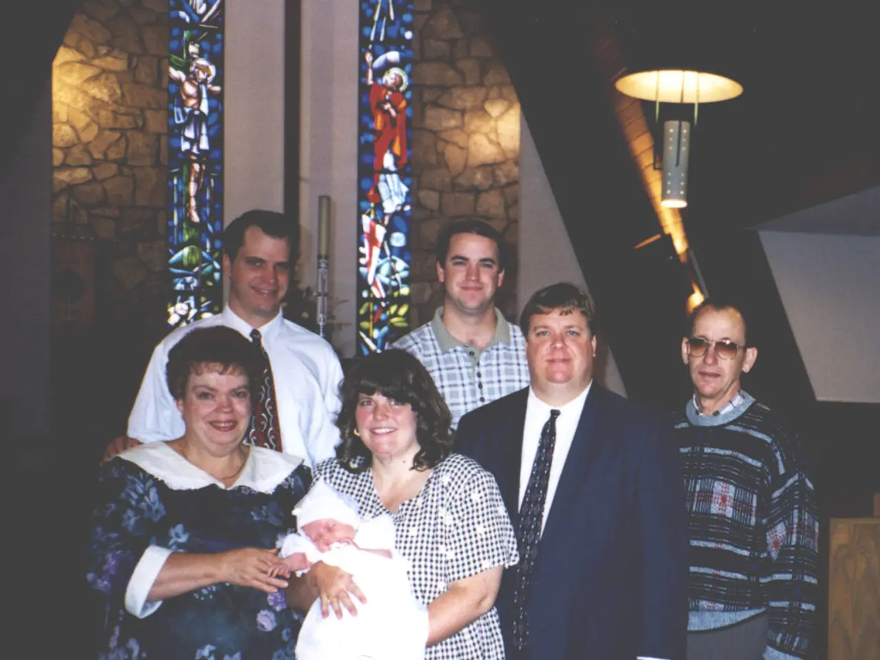 Here we can see people. This woman is holding a baby. This is light.